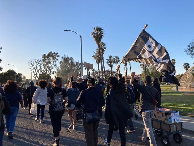 Demonstrators marching on the street of Marina Vista Park for Black History Month around 5:00 p.m. Photo credit: Reann Wenceslao