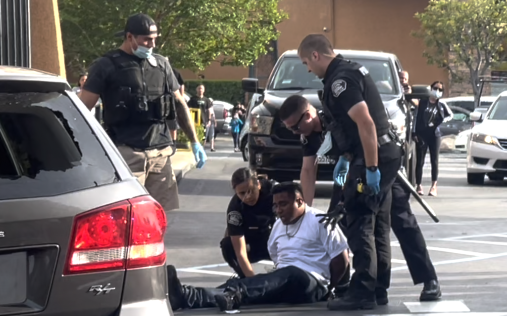 FPD officers handcuffed a second suspect involved in a high-speed pursuit in the city of 
Fullerton. Photo credit: Joe Trujillo