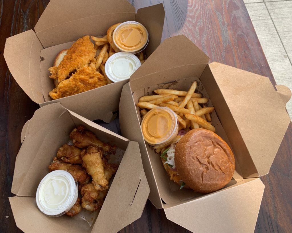 Seen here are the Caramel Soy wings, the spicy chicken sandwich, and a 3-piece chicken strip combo. Photo credit: Daniella Alvarez