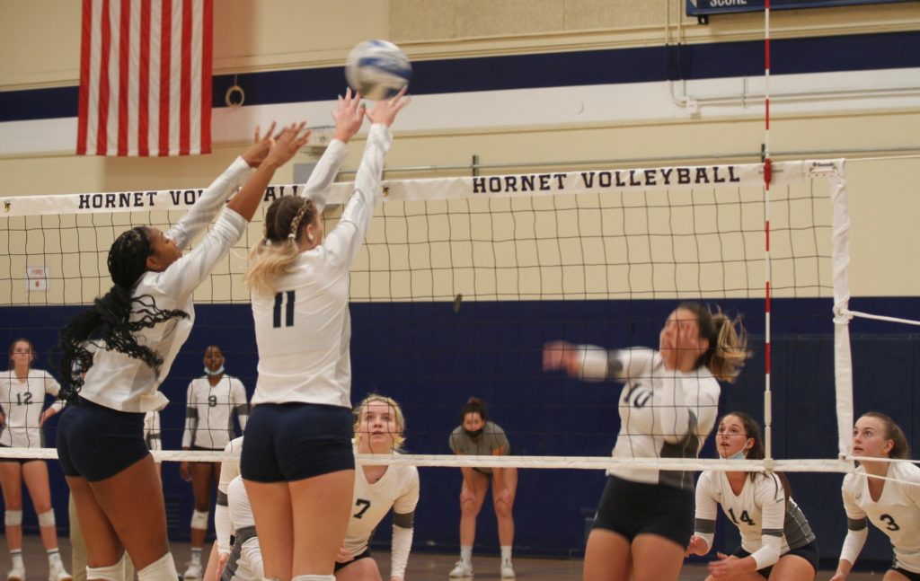 Fullerton College freshman middle blocker Jade McIntyre and sophomore outside hitter Alexis Zander attempt to block the opponents ball from reaching over their net during Wednesdays home game 3-0 loss. Photo credit: Ethan Ahoia