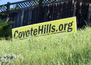 One of the many Save Coyote Hills signs peaking. Photo credit: Malia Arpon