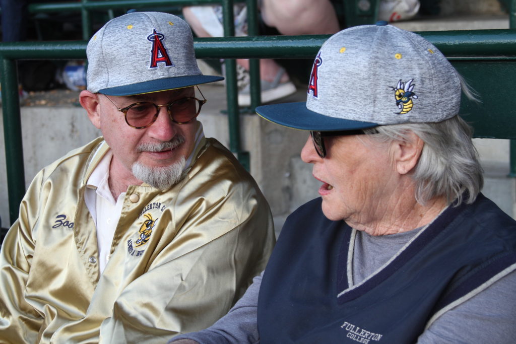 Zoot Velasco, executive director for the Friends of Fullerton College Foundation pictured with JoAnn Brannock, sporting FC and Los Angels Angels baseball hats during Saturday nights game at Angel Stadium. Photo credit: Gerardo Chagolla
