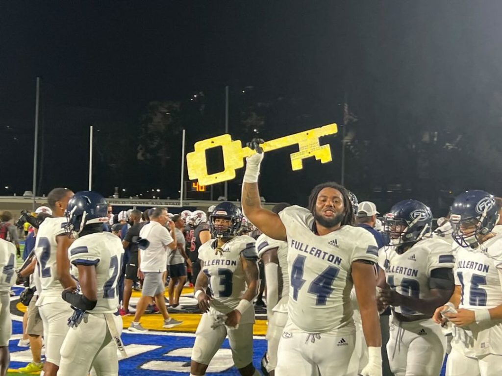 Fullerton College sophomore defensive lineman Amari Williams holds the key after the win against Santa Ana College on Saturday night. Photo credit: Matthew Gonzalez