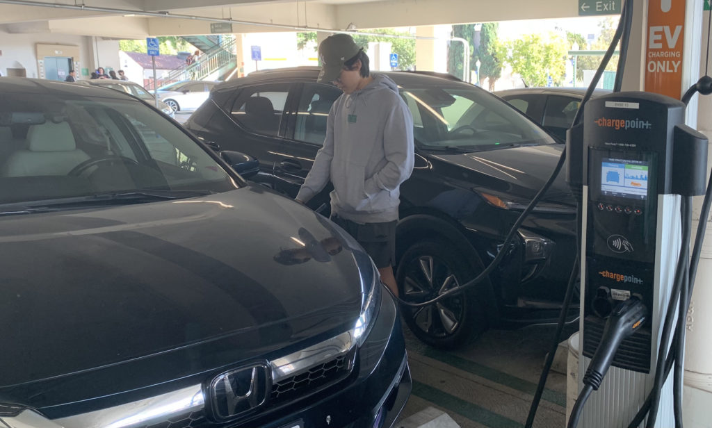 Student plugs in their car at new EV charging port Photo credit: Brooke Descalzo