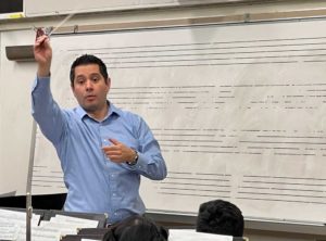 The Symphonic Winds conductor David Lopez conducts his musicians on Oct. 25, 2022 during their rehearsal for their fall concert. Photo credit: Bryan Chavez