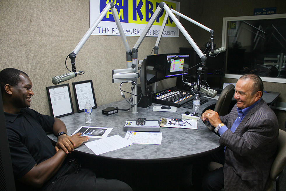 Broadcast journalism student Jay Aruya and Interim President Dr. Monte Perez share a moment during the interview in the KBPK studio. Photo credit: Aaliyah Skipper