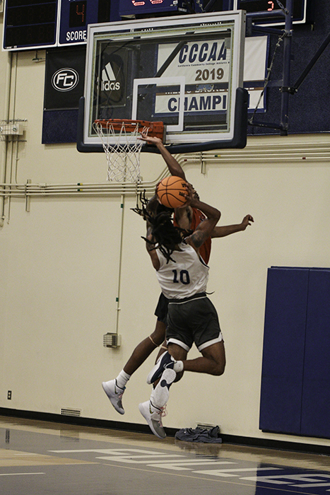 During the Thursday Oct. 20 home scrimmage game, sophomore Javon Jones drives the ball into the key looking for a jump shot only to be met by Mt. San Jacinto opponent from the inside. Photo credit: Aaliyah Skipper