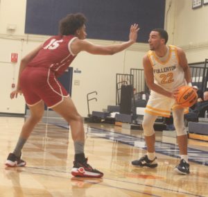 Sophomore guard Kobe Newton defends the ball from Porterville freshman forward Jalen Foy during Tuesday nights home game against Porterville Photo credit: Matthew Gonzalez