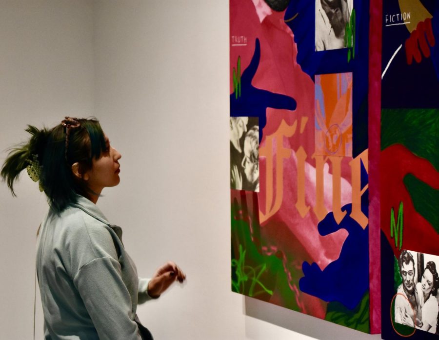 Matter of Truth or Fiction by Gabriela Sanchez. Sophomore Art Major, Adrienne Mendez looking at the abstract arts vibrant colors trying to understand the painters emotions, during the art gallery exhibition SIGNS at Fullerton College on Thursday, Feb. 9, 2023. Photo credit: Gerardo Chagolla