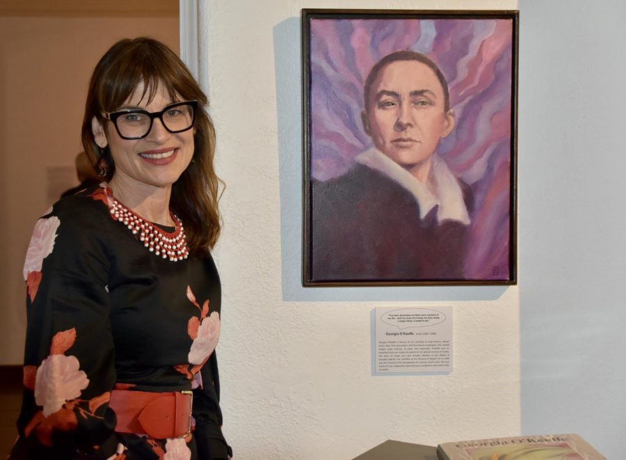 Allison Adams standing next to her portrait of