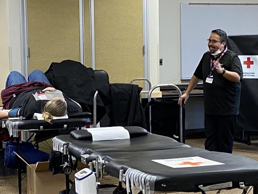 Blood donor Kimberly Rubalcaba having a conversation with event coordinator Obed Martinez on Fullerton College's American red cross blood drive.