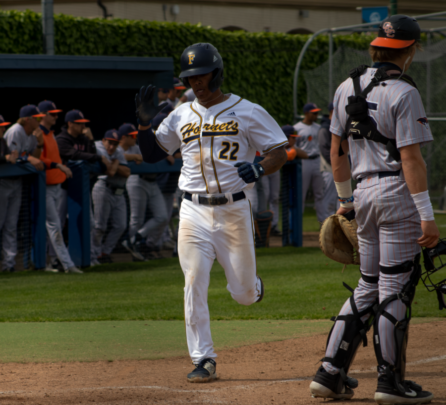 Fullerton outfielder Isaiah Marquez scores easily in the third inning, but his run would not be enough in the Hornets 8-5 loss to OCC at home on Friday, Mar. 31.