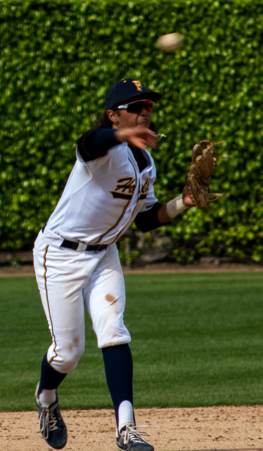 Fullerton shortstop Jimmy Blumberg makes a quick throw to first base in the Hornets 8-5 loss to OCC on Friday, Mar. 31.