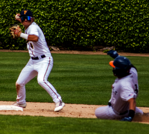 Fullerton second baseman Jared Benash avoids the slide of Orange Coast outfielder Evan Scalley as he turns the double play in the third inning against OCC at home on Friday, Mar. 31. Photo credit: Bryan Chavez