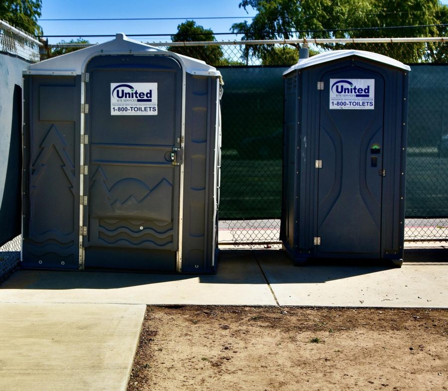 The women's softball field doesn't have traditional restrooms. Game attendees and the girls that play here have to attain to their personal matters in these portable potties.
