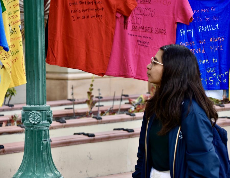 Wendy Medina a sophomore film major at Fullerton College says the writing on the t-shirts are "very impactful" at the Clothesline Project on Tuesday, April 18, 2023.