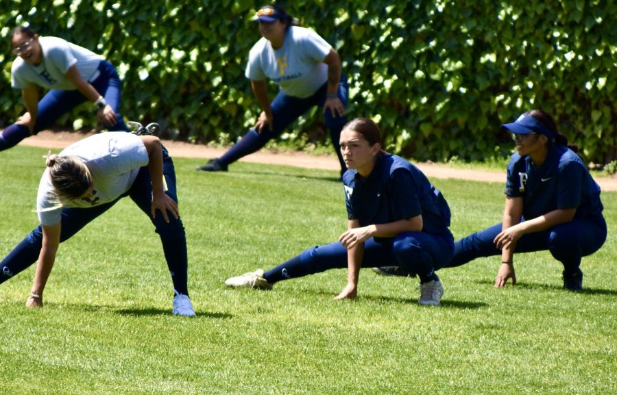 Fullerton College softball team stretches before practice. Some players are frustrated with lack of equivalent facilities. Photo credit: Gerardo Chagolla