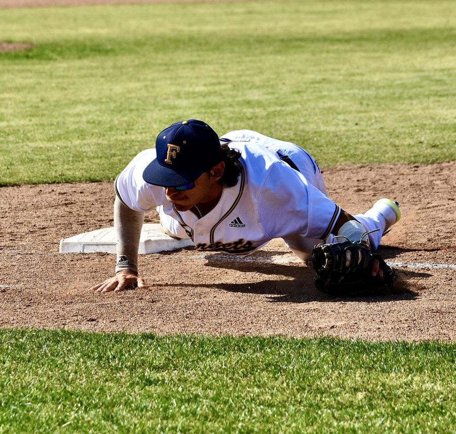 Freshman first baseman Tank Esplain saves an errant throw from sophomore second baseman Jared Benash, keeping a toe on the bag to secure the out at home on Thursday, May 11, 2023.