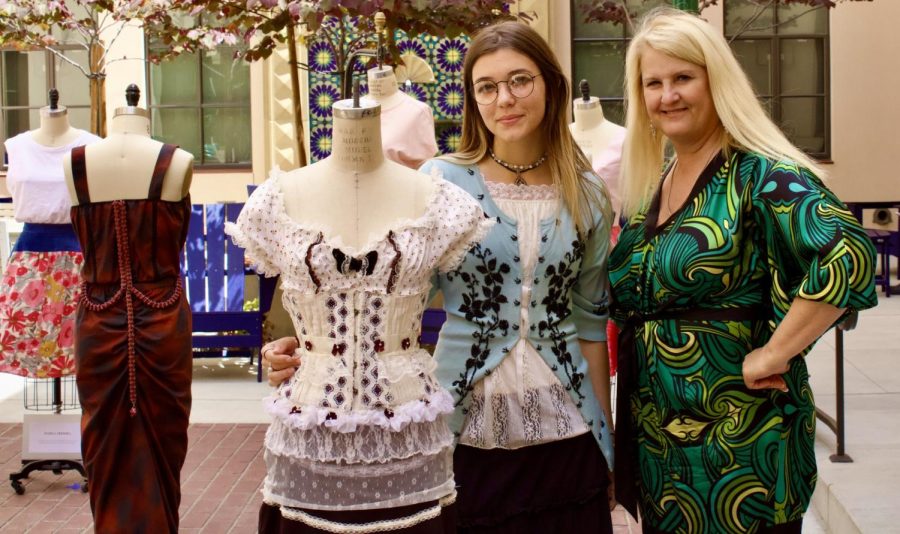 Jennifer Muresan (right) and Renee Young(left), standing next to Muresan scholarship winning piece during the showcase.