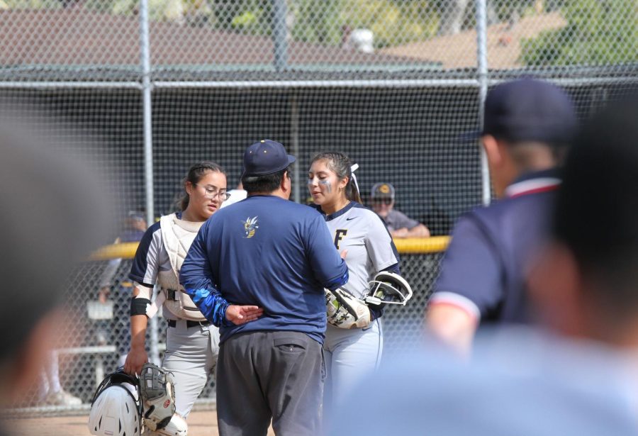 Coach Brain Iseri, Allyson Fuentes and Serina Vue having a talk in the circle at Fullerton College on Friday May 05, 2023.