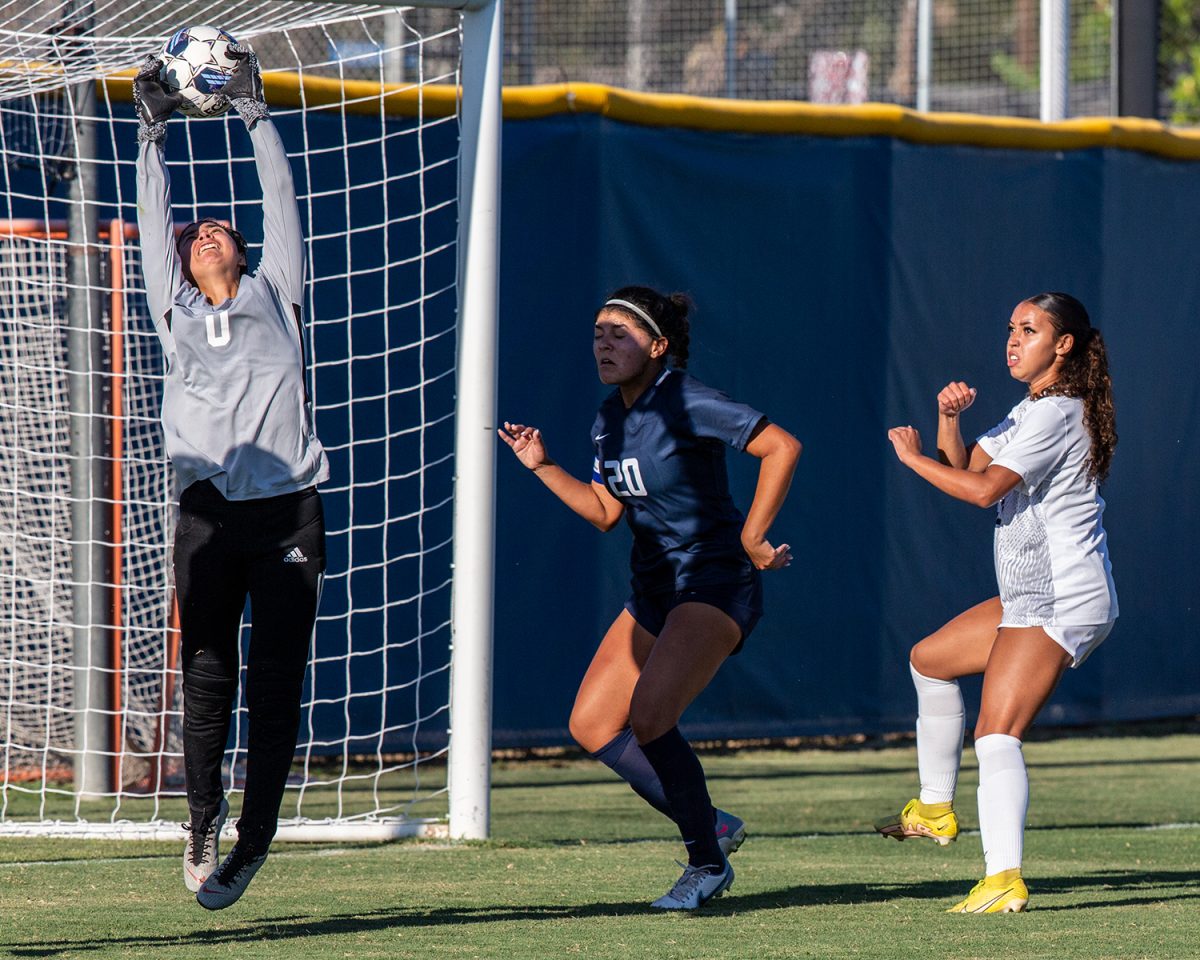 Freshman goalkeeper Nyla Contreras skies to the top cross bar to make a save for the Hornets at their home opener on Tuesday, Aug. 29, 2023.