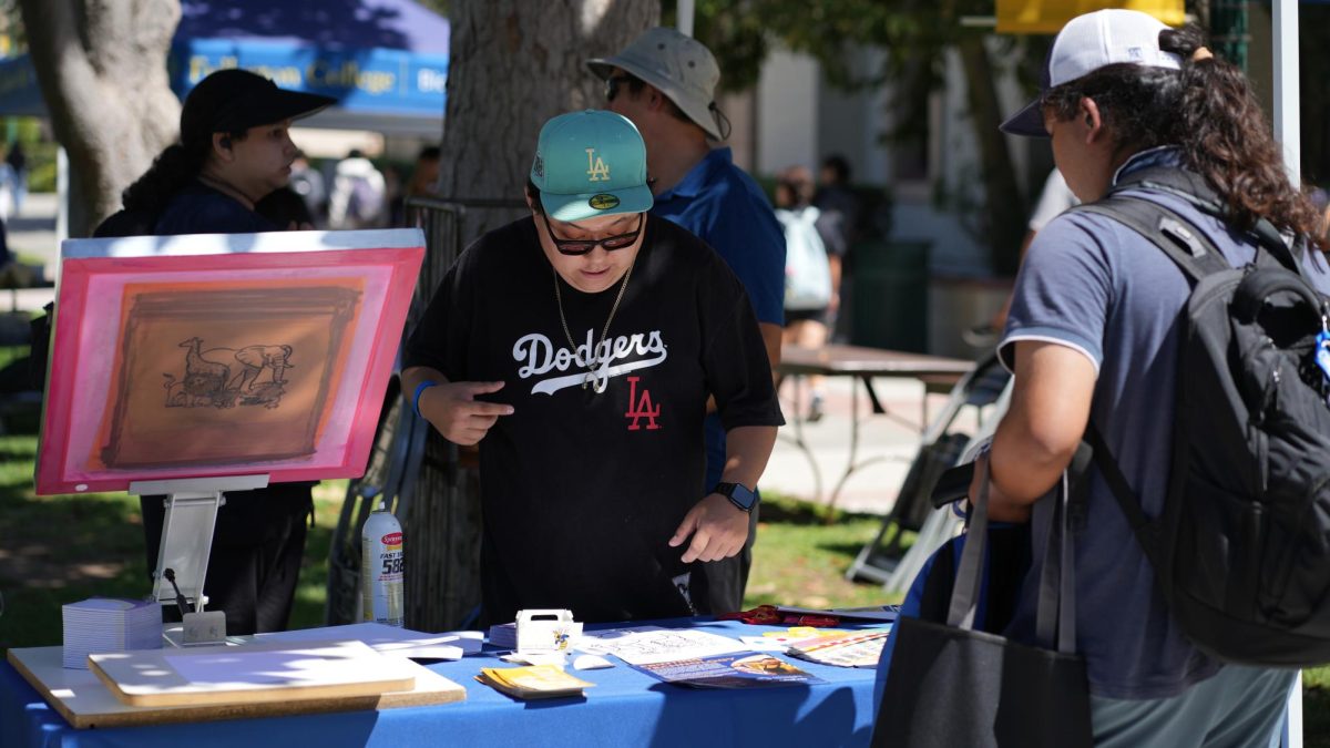 Students participate in screen printing at printing technology booth at Fullerton Colleges Welcome Fair on Tuesday August 29, 2023.