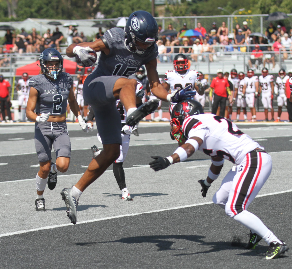 Freshman wide receiver Leland Smith attempts to hurdle over a Mt. San Jacinto defender at Fullerton College on Sept. 23, 2023.