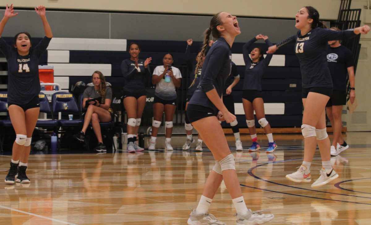Freshman outside hitter Emily Finnegan gets her teammates fired up during a back and forth match on her home floor.