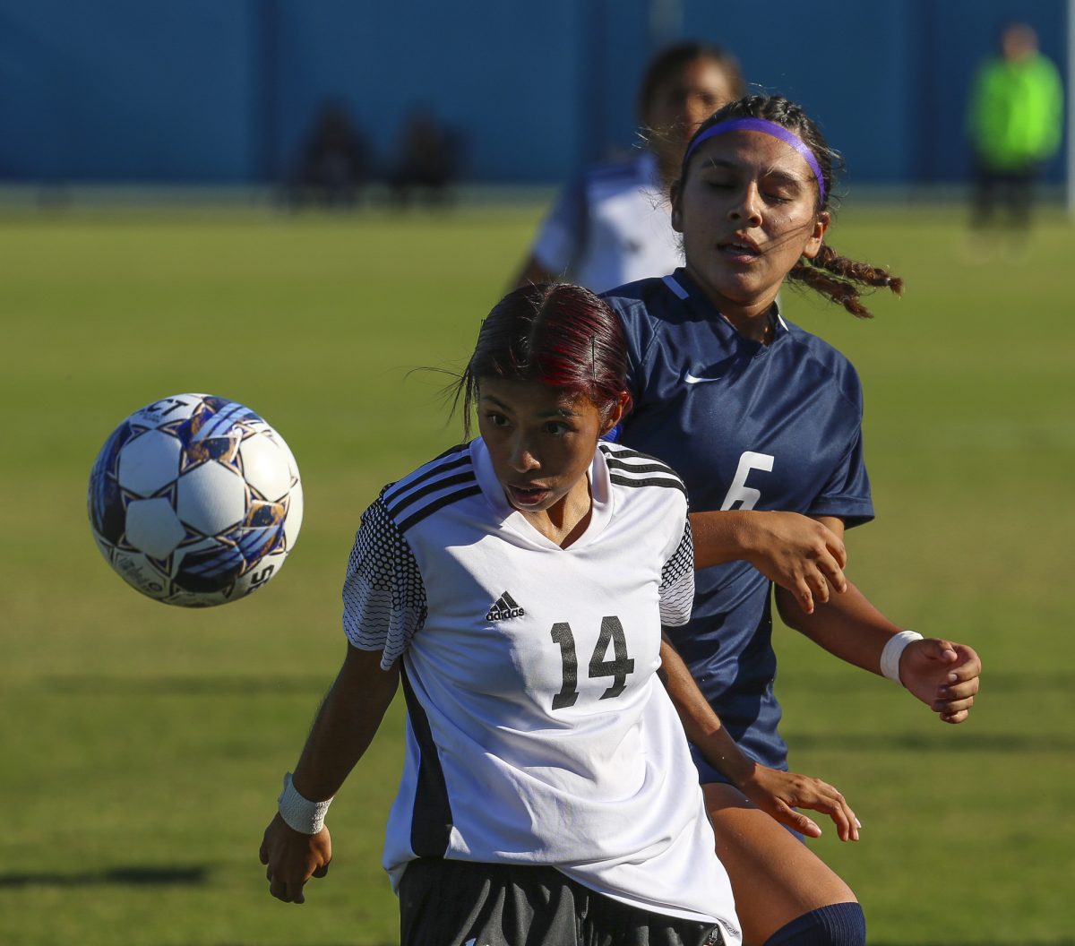 Santa Anas defender Samantha Gomez (white) uses her extreme focus and effort to keep Fullertons super striker Sheccid Carrillo (blue) away from potentially scoring another goal on Tuesday, Oct. 3, 2023. 