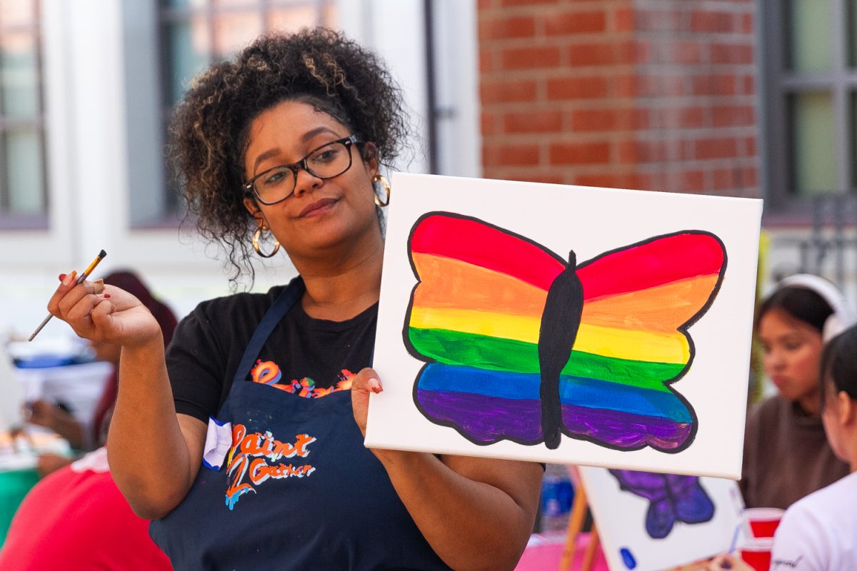 Art instructor Seranie Ruiz teaches students how to paint a butterfly that represents both undocumented and LGBTQIA2S+ students on Oct. 18, 2023.