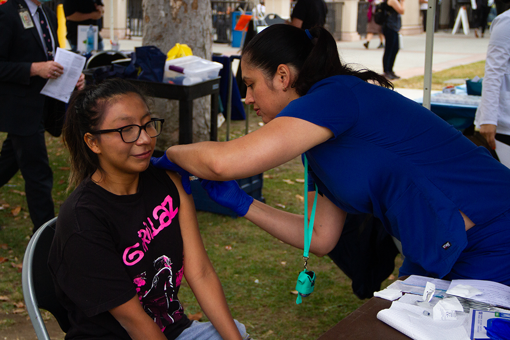 Tami Kahn RN from the Health Center gives Stephanie Ortega a flu shot at the Health Centers flu vaccination clinic on Wednesday, Oct.11, 2023.