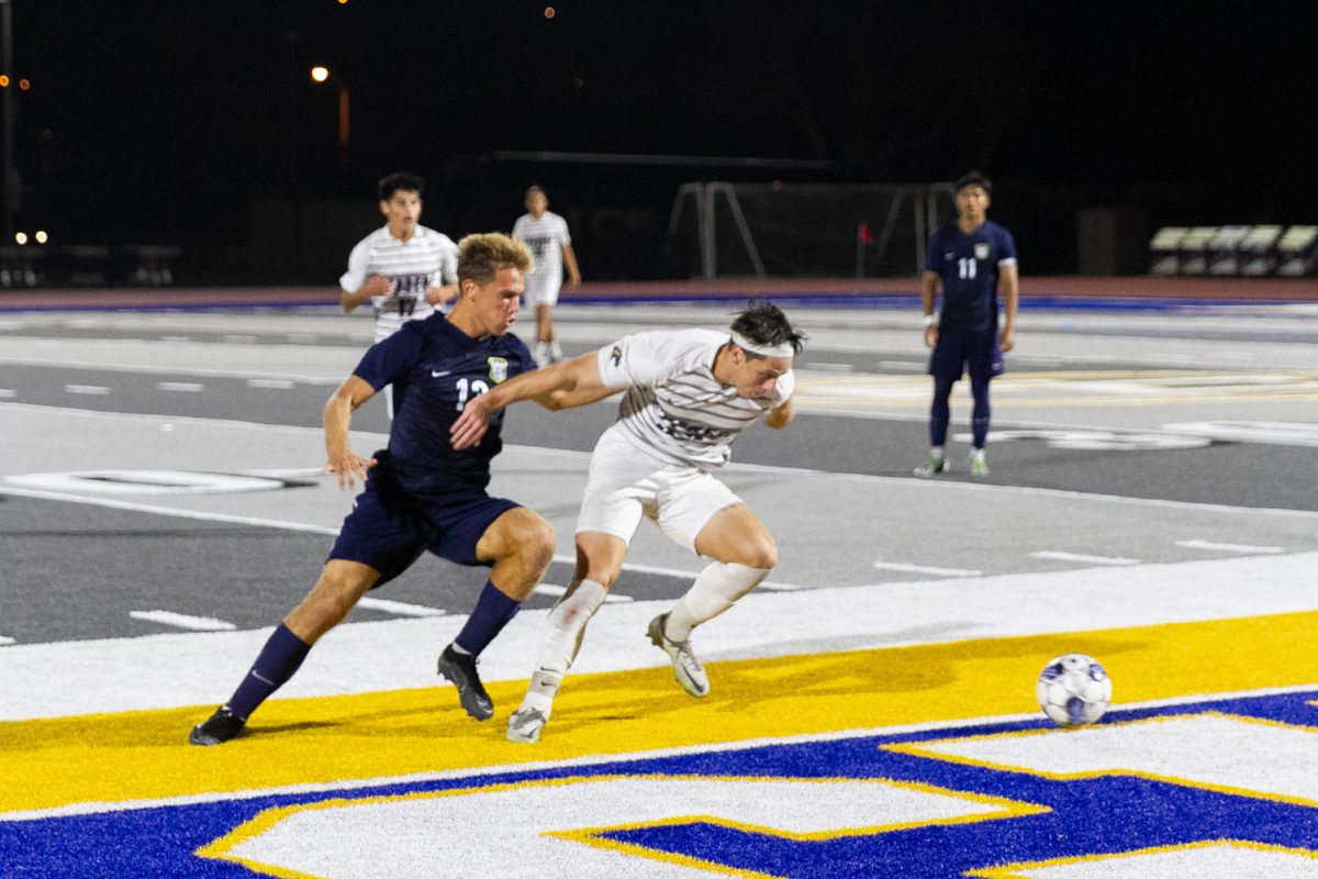 Freshman forward Hayden Kenny battles for possession against Cypress College at home on Oct. 13, 2023.