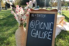 Picnic Galore displays their Instagram and Tiktok on a chalkboard and gets most of their clientele that way.