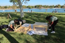 Pictured here are Frida Olvera and her mom beginning the picnic set up by assembling the picnic tables at Lake Balboa in Van Nuys.