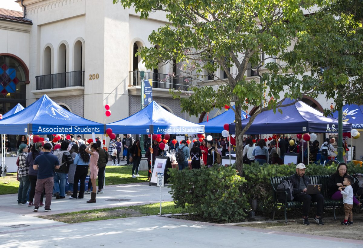 Associated Students-branded canopies furnish shade for attendees of the Lunar New Year celebration, which is doubling as a Club Rush event.  The event is sited in the northwest corner of the quad, in front of the recently rededicated Cruz Reynoso Hall.  Feb. 8, 2024.