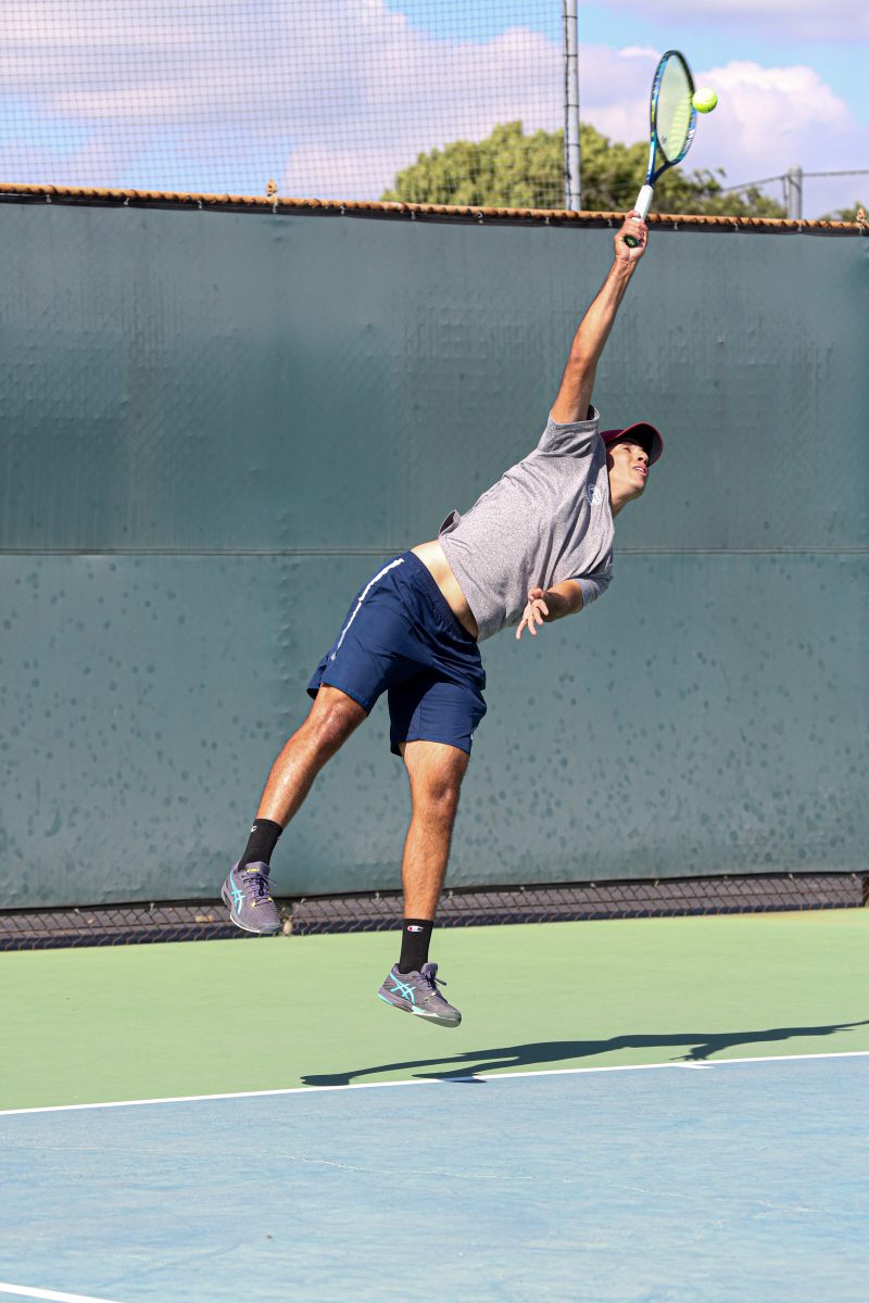 Freshman Felix Jayamaha with a wicked serve to clinch a win against Santa Barbra City College in his singles match on March 28, 2024.