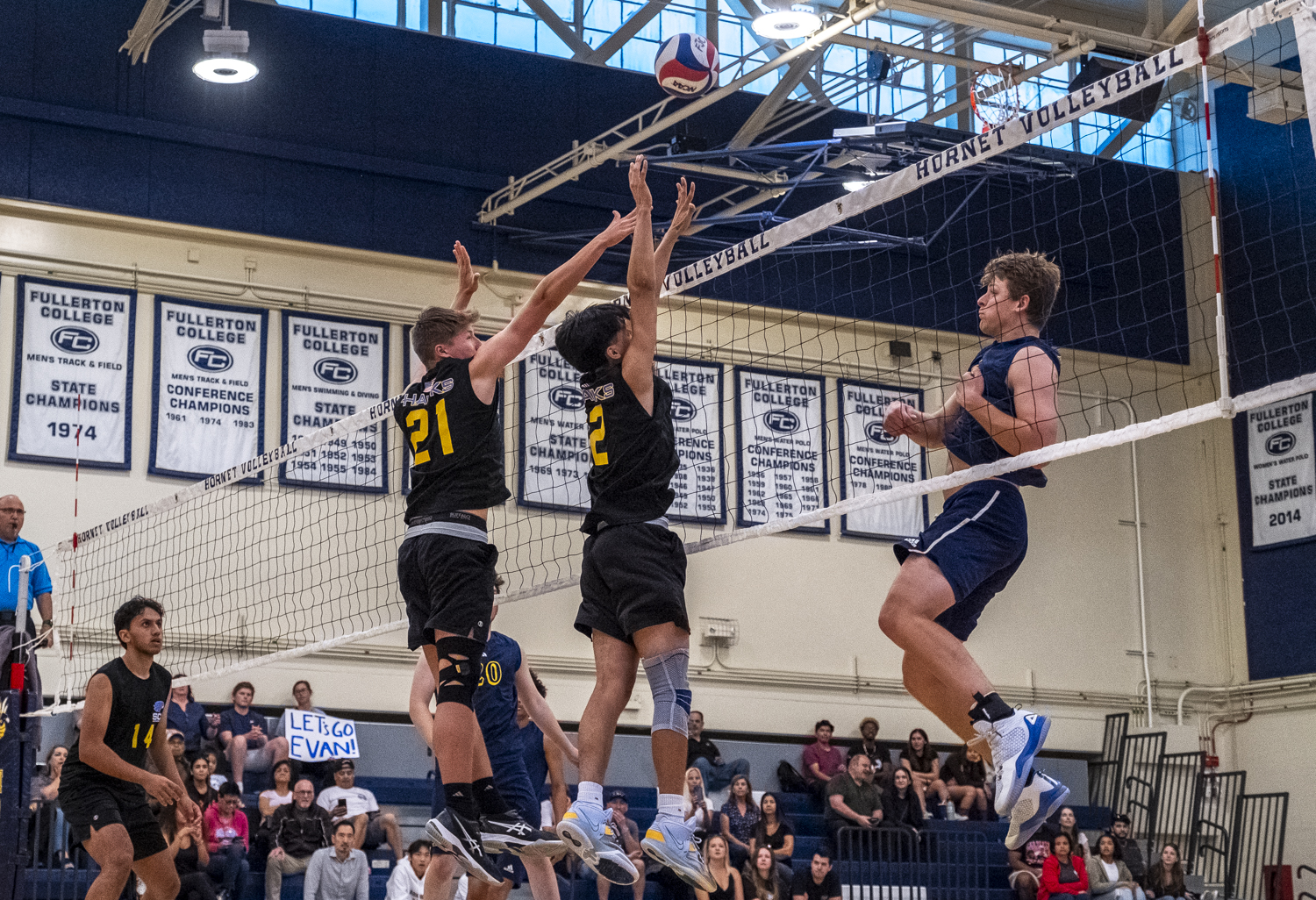 Hornets freshman Caden Smith delivers a powerful spike into the arms of defending Hawks players, sending the ball upward and into the visiting team’s territory during the men’s volleyball match on Wednesday, April 10, 2024.