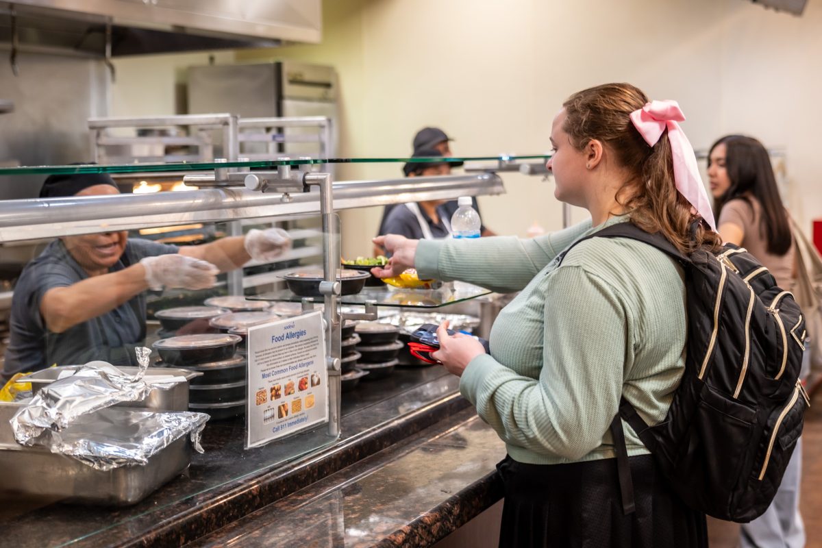 Third year student Sarah Fristensky, receives her free meal at the Hornet’s Cafeteria on Monday, August 26, 2024. The cafeteria, managed by Sodexo, has drawn criticism from students due to the lack of healthy food options and lack of variety.