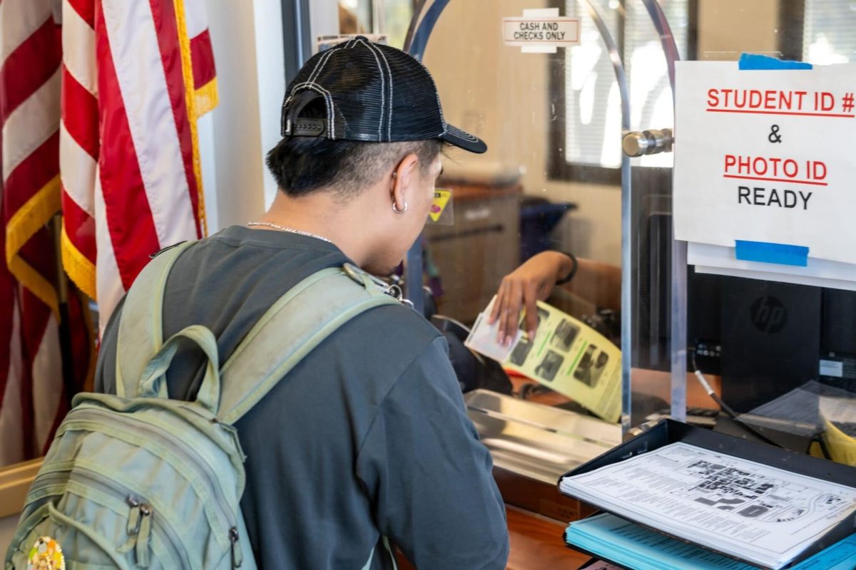 First year student Benji Ranada picks up his parking permit at the Campus Safety office on August 26, 2024.