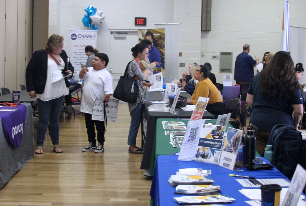 Attendees looking for jobs get more information at booths at the Department of Rehabilitation job fair at the Brookhurst Community Center in Anaheim on Sept. 26, 2024.