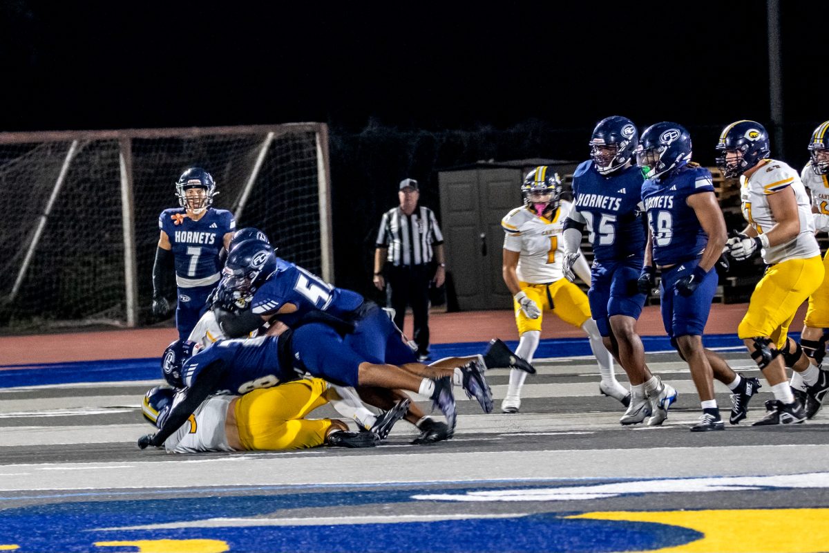 Hornets' defensive team shown tackling Canyon's player on Saturday Sept 14,2024