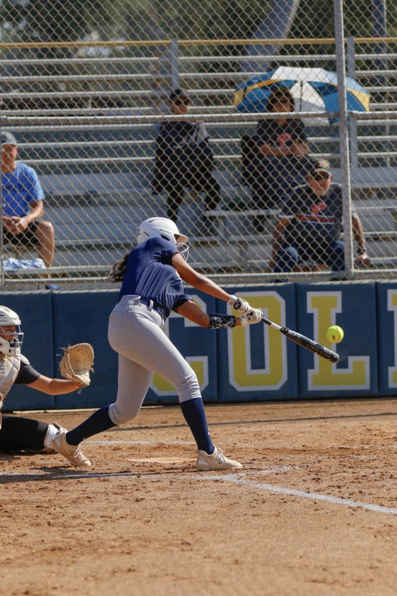 Batter Lynsey Arostigue connects with the ball. 