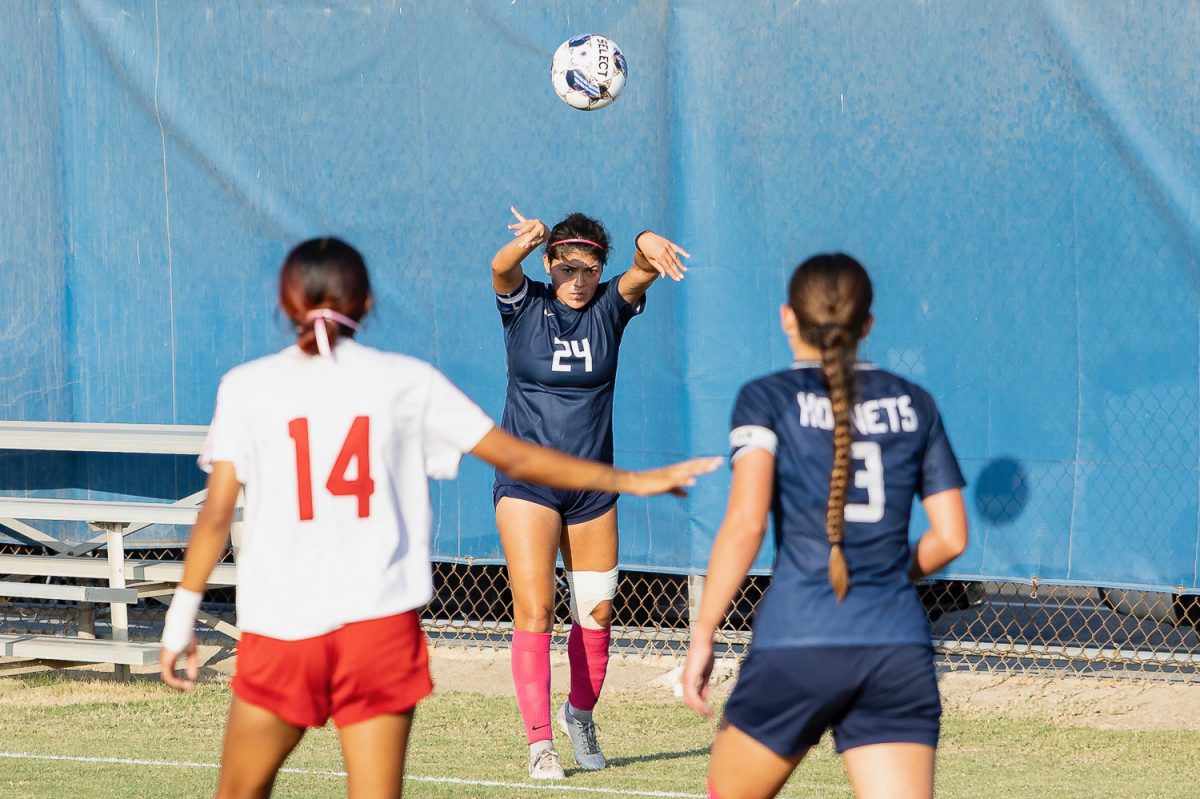 Natalia Villegas throws the ball into play as Danielle Narmi and Sammantha Gomez await the ball on Tuesday, Oct. 15, 2024.