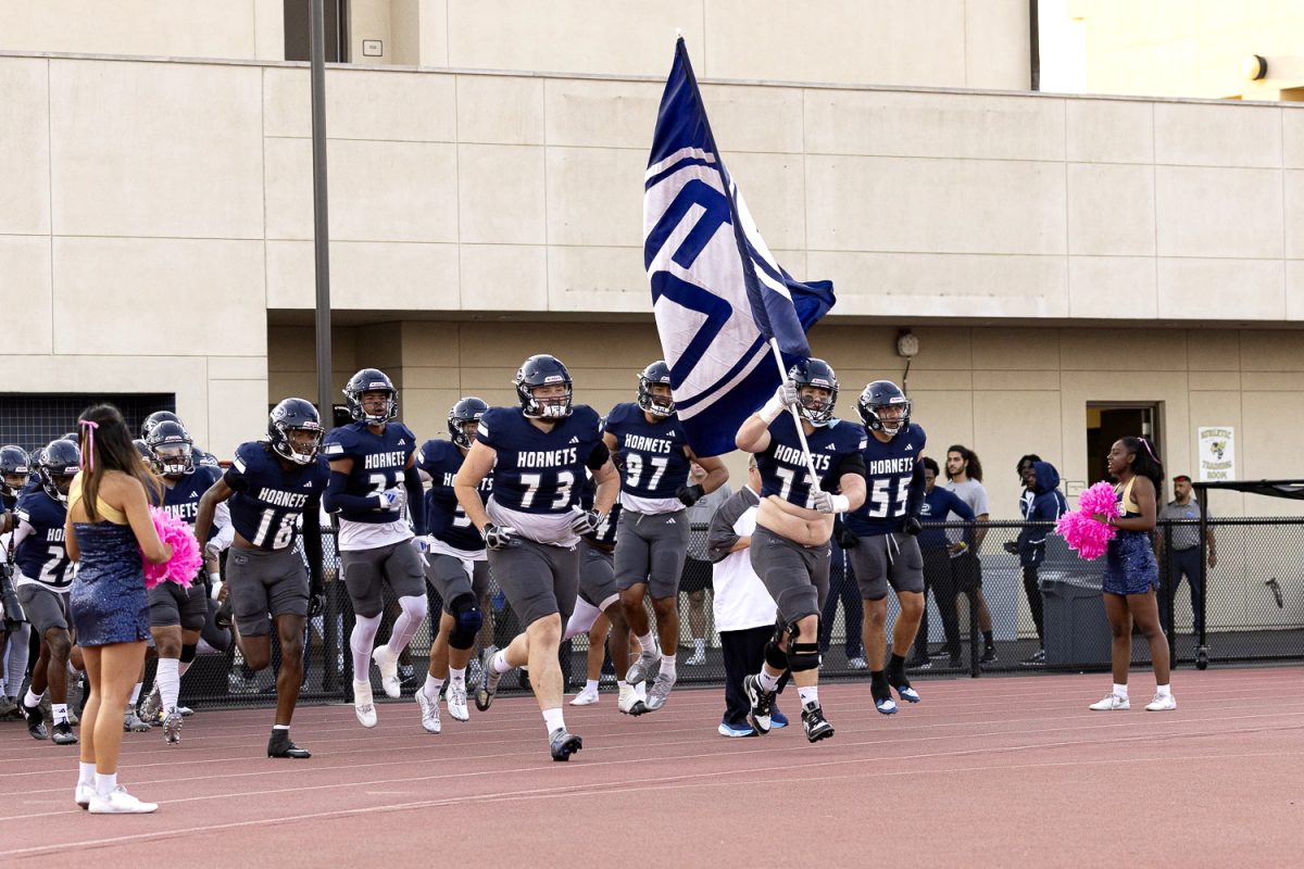 Ryley Miller holds the Fullerton flag as he leads The Hornets onto the field to face The Southwestern Jaguars on Oct. 5, 2024.