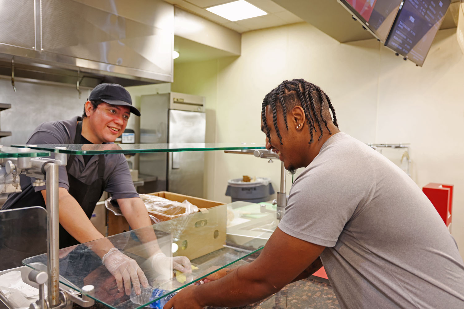 First-year sports management student Jalen Handford grabs his free meal from the dining hall on Oct. 23, 2024. The meal of the day is barbecue chicken, mashed potatoes and vegetables. 