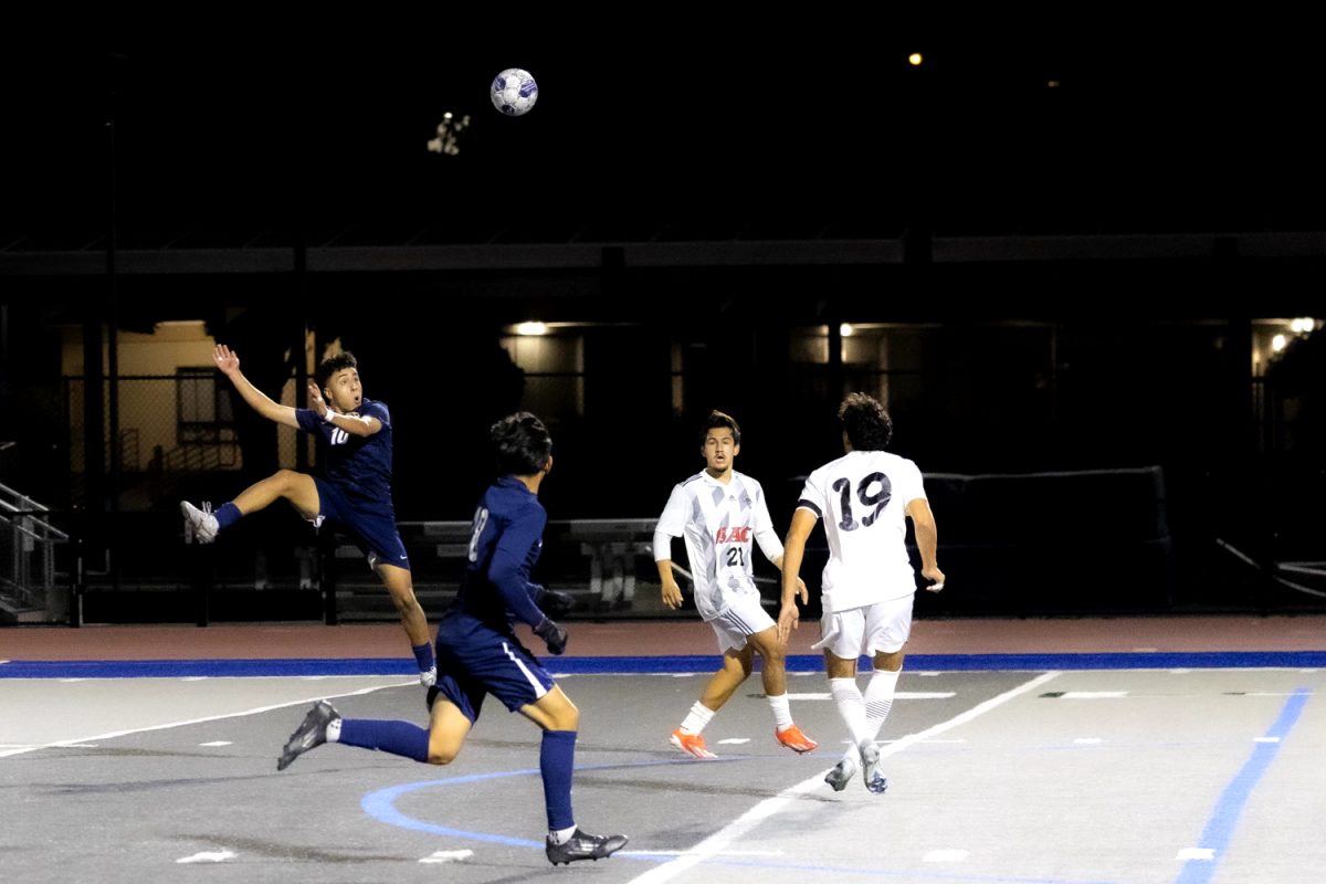 Fullerton midfielder Cesar Marquez heads the ball on Friday, Nov. 8, 2024.