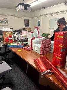 CARE staff worker Amy Moreno busy wrapping gifts for event on Nov. 26, 2024. 