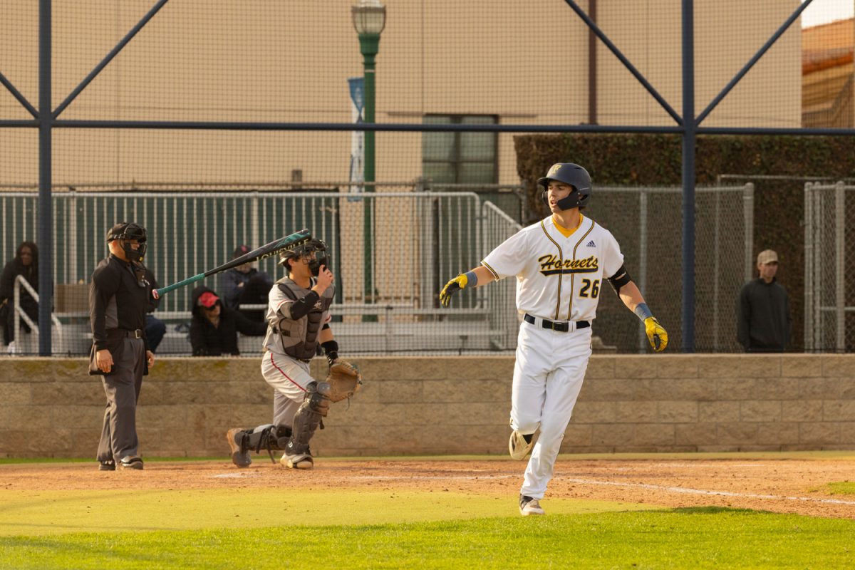 Jake Starr throws his bat aside as he runs to first base.