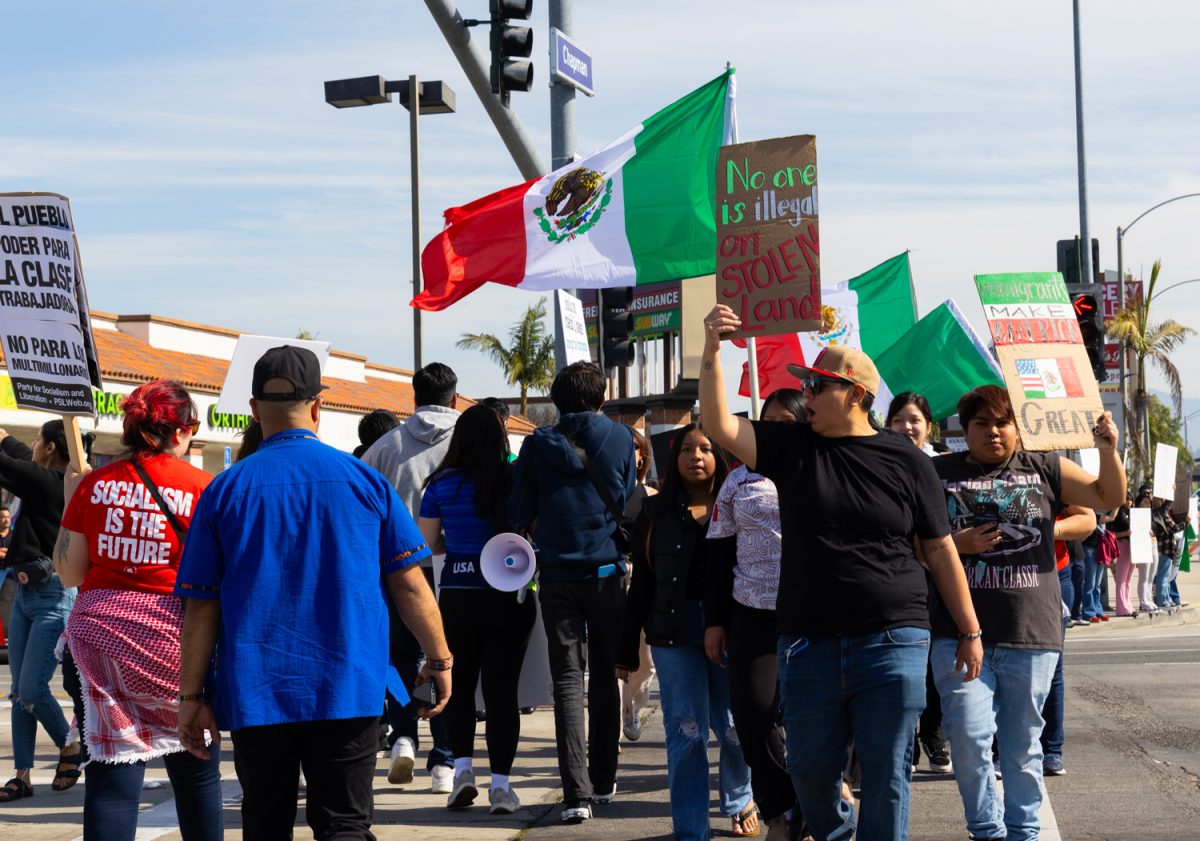 Demonstrators gather at Chapman Ave, crossing the streets and making rounds about the intersection.