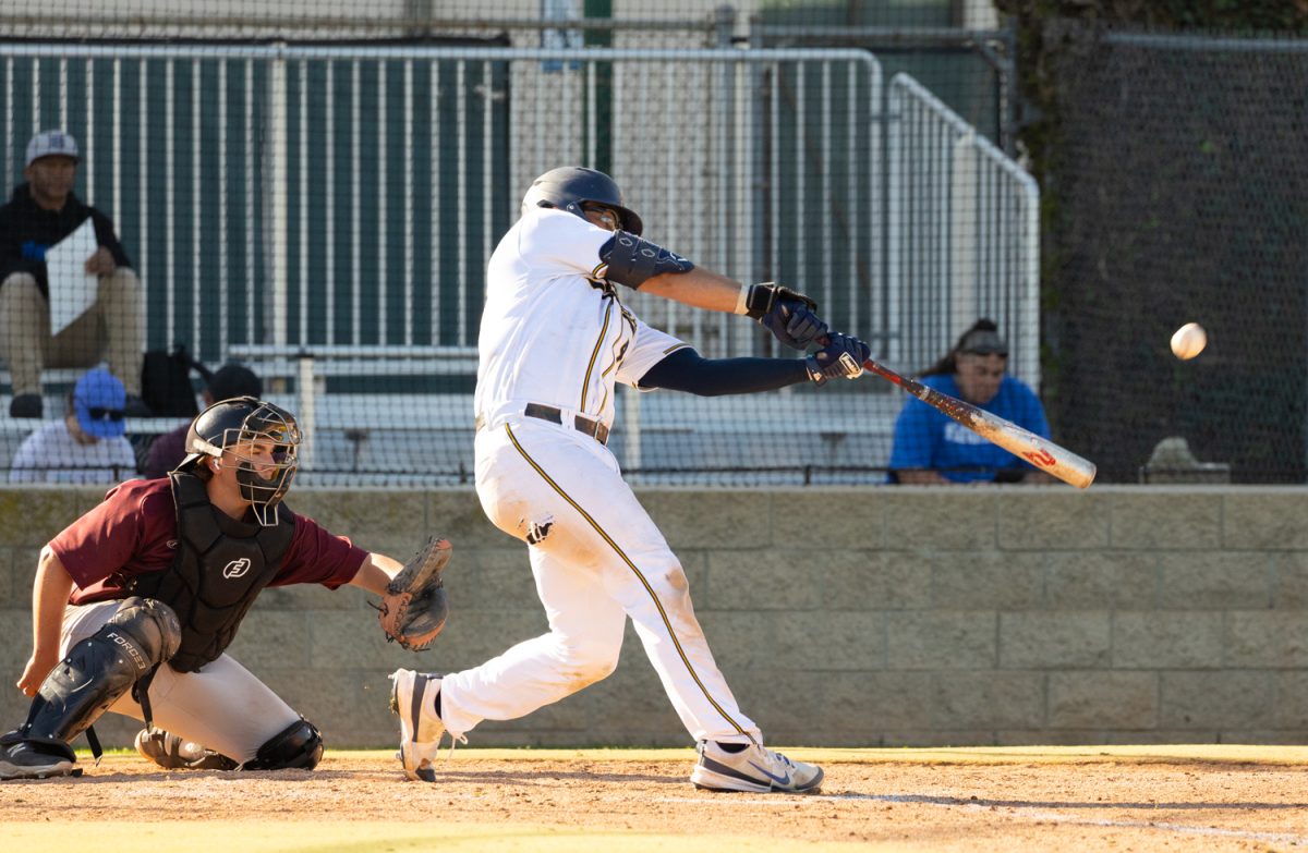 Trevor Schmidt knocks the ball helping Nate Pone bring in another run for the team at the home game vs Southwestern College on Feb. 25, 2025.